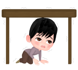 地震で机の下に避難をする人のイラスト